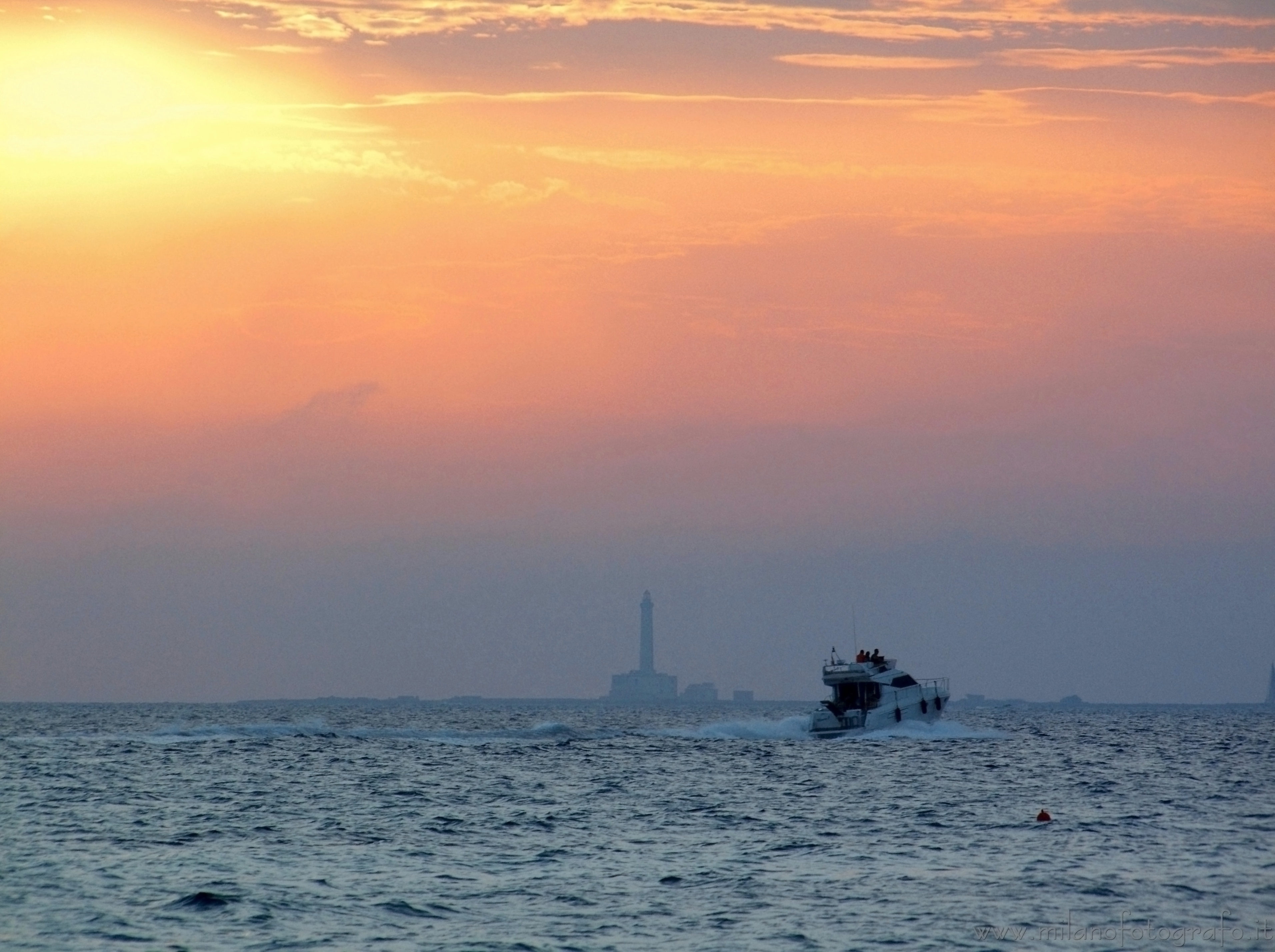 Baia Verde fraction of Gallipoli (Lecce, Italy) - Sunset with Sant'Andrea Island and boat